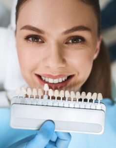 Smiling woman is choosing veneers stock photo